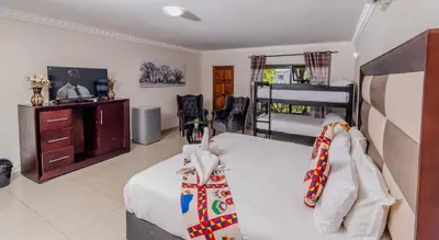 a bedroom with two beds and a bunk bed at ASANTE MOUNTAIN LODGE in Hazyview