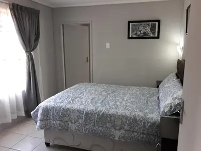 a bedroom with a bed and a window at Wild Escape in Marloth Park