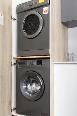 a washer and dryer sitting in a kitchen at Menlyn Apartment - Marble Print in Pretoria