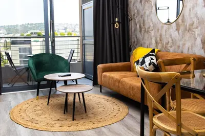 a living room with a couch and chairs and a table at Menlyn Apartment - Marble Print in Pretoria
