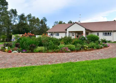 a garden in front of a house with flowers at Amohela Guesthouse in Midrand