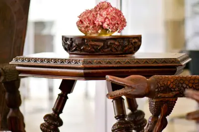 a wooden table with a bowl of flowers on it at Amohela Guesthouse in Midrand
