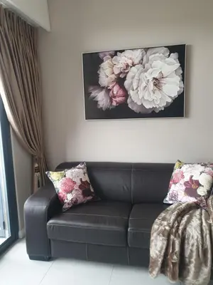 a black leather couch in a living room with a painting at Menlyn Maine in Pretoria