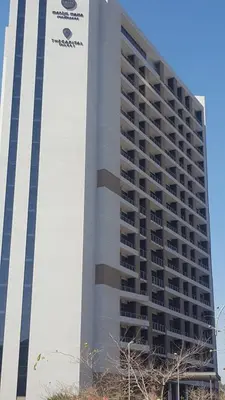 a tall building with a sign on the side of it at Menlyn Maine in Pretoria