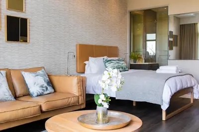 a living room with a bed and a couch at Menlyn Residence in Pretoria