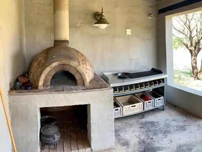 a large brick oven with a stove in a kitchen at Tula Baba Game Lodge in Brits