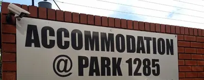 a sign on the side of a brick wall at Accommodation@Park1285 in Pretoria