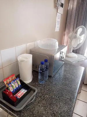 a kitchen counter with a sink and a mixer at Accommodation@Park1285 in Pretoria