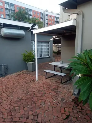 a patio with a picnic table on a brick patio at Accommodation@Park1285 in Pretoria