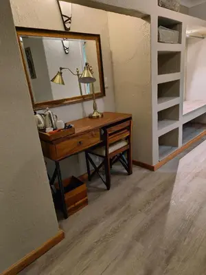 a bathroom with a vanity with a mirror and a sink at BushTime Mabula in Mabula