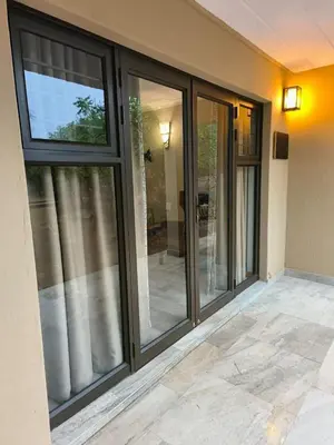 a screened porch with sliding glass doors at BushTime Mabula in Mabula