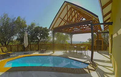 a patio with a swimming pool and a pavilion at BushTime Mabula in Mabula