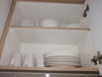 a shelf with plates and other dishes in a kitchen at The Blyde Modern Oasis Pretoria in Pretoria