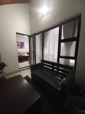 a room with a couch and a large window at The Blyde Modern Oasis Pretoria in Pretoria
