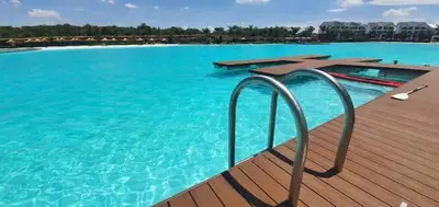 a large pool of blue water on a wooden deck at The Blyde Modern Oasis Pretoria in Pretoria