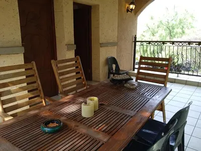 a wooden table with two candles on top of a balcony at Aloha Lodge 2 Bedroom Apartment near Menlyn Sleeps 4 in Pretoria