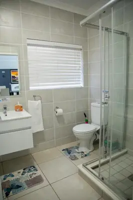 a bathroom with a shower and a toilet and a sink at Lush Living The Blyde Riverwalk Estate Unit 101 in Pretoria