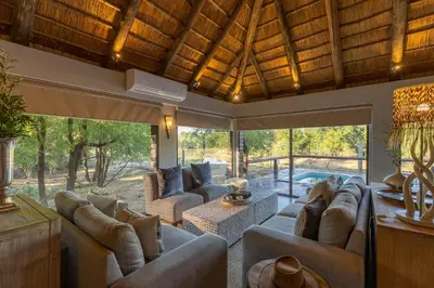 a large living room with couches and a pool at Karongwe - River Safari Lodge in Hoedspruit