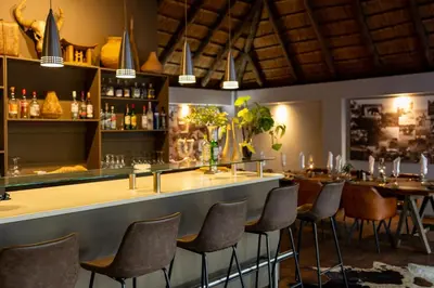 a bar at a restaurant with tables and chairs at Karongwe - River Safari Lodge in Hoedspruit