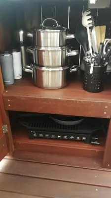 a cabinet with pots and pans on top of it at Kruger River Villas- Treetop Loft in Marloth Park