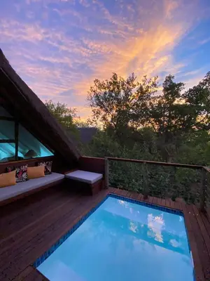 a swimming pool on the deck of a house at Kruger River Villas- Treetop Loft in Marloth Park