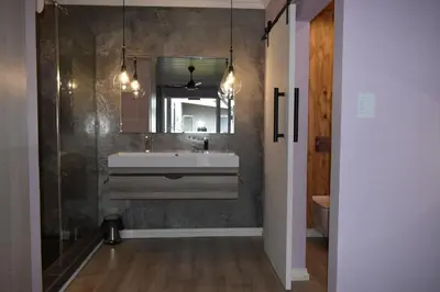 a bathroom with a sink and a mirror at Mosswood Bed & Breakfast in Graskop