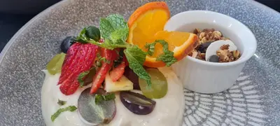 a plate of food with fruit and vegetables on it at Mosswood Bed & Breakfast in Graskop