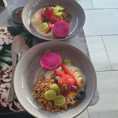 two bowls of food with fruit and nuts in them at Mosswood Bed & Breakfast in Graskop