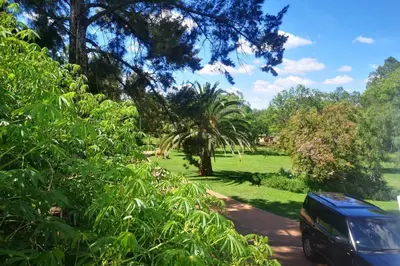 a blue van parked on a road in a field at Rural feeling Self Catering Next door to Sandton in Midrand