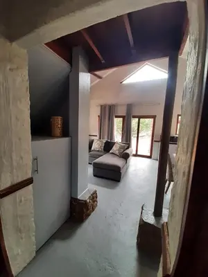 a living room with a couch and a table at Rock Cottage, Bela-Bela in Bela-Bela