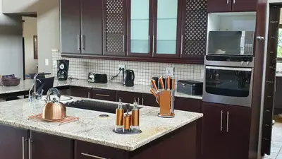 a kitchen with a counter with a sink and a stove at Zwartkloof View, Bela Bela in Bela-Bela