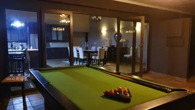 a pool table in a living room with a pool table at Zwartkloof View, Bela Bela in Bela-Bela
