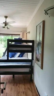 a bedroom with a bunk bed with a picture of a boat at Zwartkloof View, Bela Bela in Bela-Bela