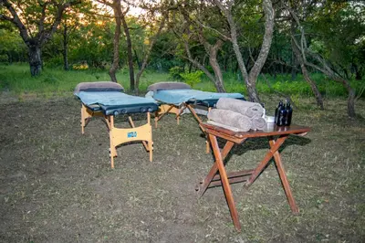 a group of three picnic tables in the grass at Thornhill Safari Lodge in Hoedspruit