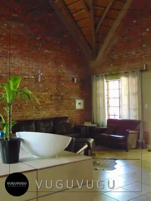 a living room with a large white bowl on a table at VuguVugu - At home in Africa in Marloth Park