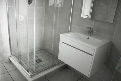 a bathroom with a shower and a sink at 396 The Blyde Crystal Clear Lagoon 2 Bedroom Penthouse Apartment in Pretoria