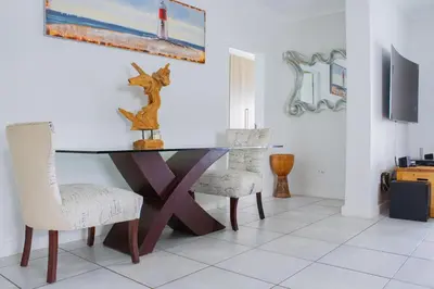 a dining room with a glass table and two chairs at 396 The Blyde Crystal Clear Lagoon 2 Bedroom Penthouse Apartment in Pretoria