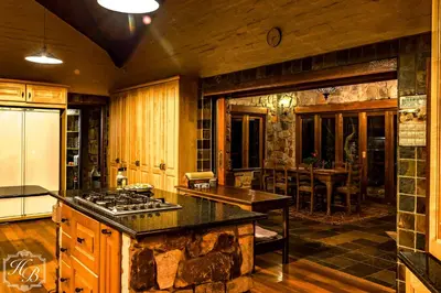 a kitchen with a stove top oven in a room at Heysbrook Estate - Luxurious lodges in a private valley in Waterval-Onder