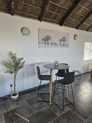 a table and chairs in a room with a plant at 636 Itaga Safari Lodge, Mabalingwe Nature Reserve in Mabula