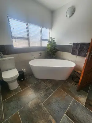 a bathroom with a white tub and a toilet at 636 Itaga Safari Lodge, Mabalingwe Nature Reserve in Mabula