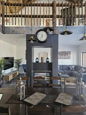 a living room with a fireplace and a clock at 636 Itaga Safari Lodge, Mabalingwe Nature Reserve in Mabula