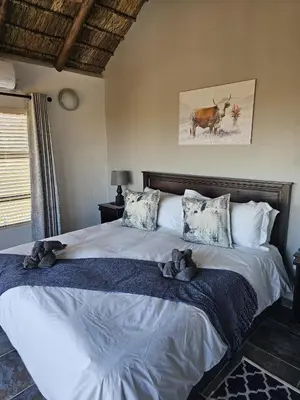 a bedroom with a large bed with teddy bears on it at 636 Itaga Safari Lodge, Mabalingwe Nature Reserve in Mabula