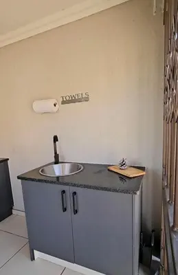 a bathroom with a sink and a roll of toilet paper at Mminanoko Eco Guesthouse in Mamphokgo