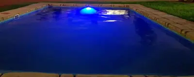 a swimming pool with blue water in a yard at Mminanoko Eco Guesthouse in Mamphokgo