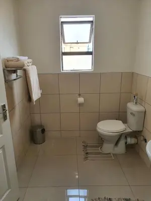 a bathroom with a toilet and a window at Mminanoko Eco Guesthouse in Mamphokgo