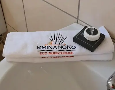 a white towel sitting on top of a bathroom sink at Mminanoko Eco Guesthouse in Mamphokgo