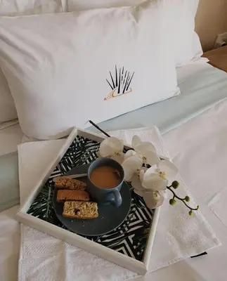 a tray with a cup of coffee and cookies on a bed at Mminanoko Eco Guesthouse in Mamphokgo