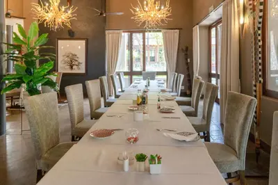 a long dining room with a long table and chairs at Zebula Boutique Hotel in Mabula