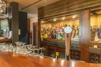 a bar with a clock on the wall of a bar at Zebula Boutique Hotel in Mabula
