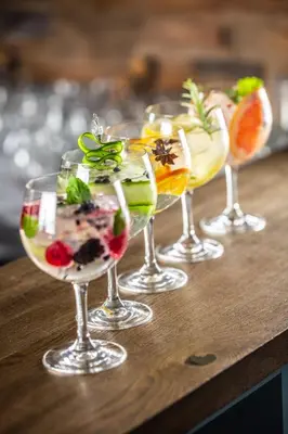 a group of four wine glasses sitting on a table at Zebula Boutique Hotel in Mabula